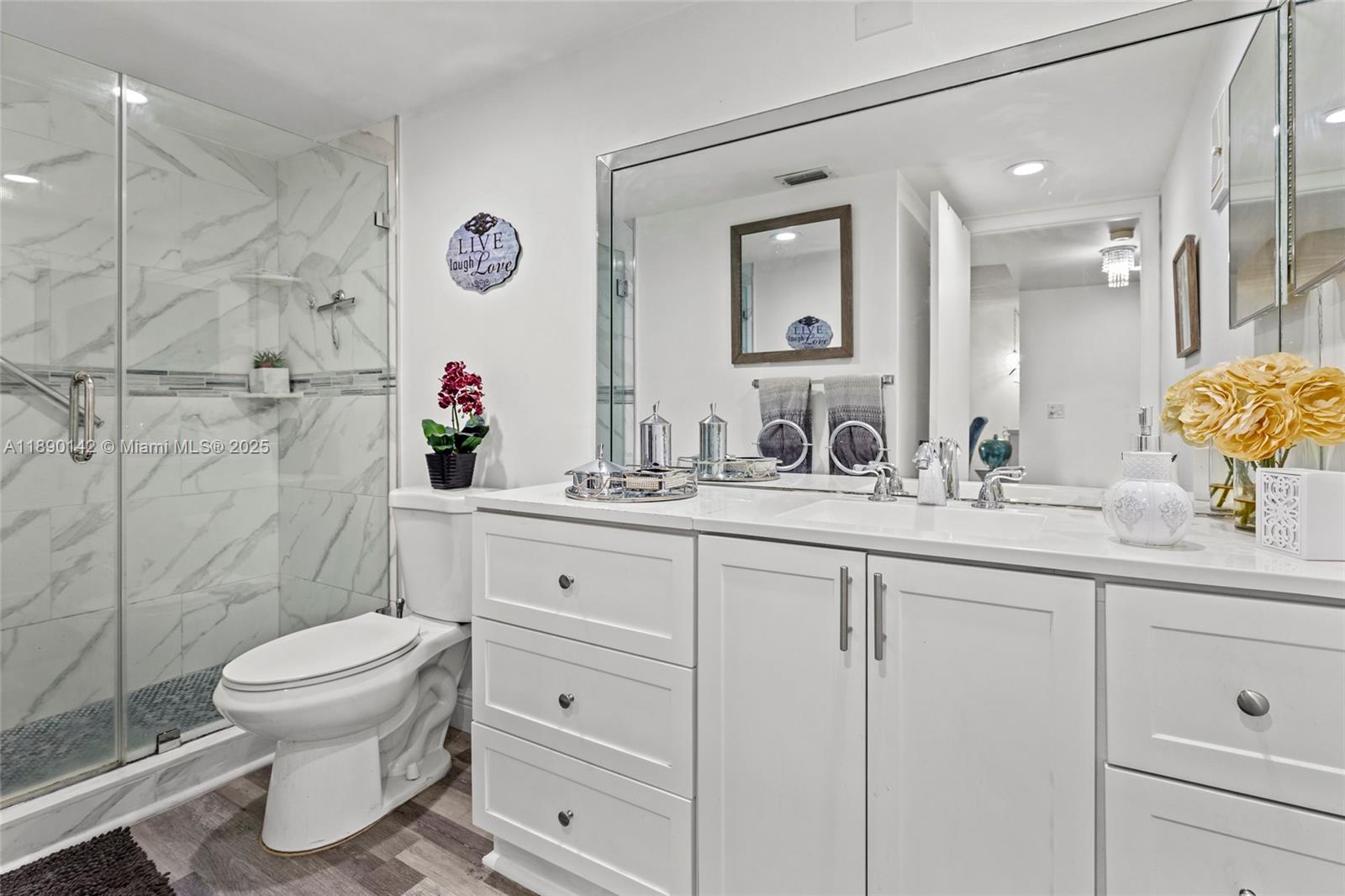 10400 Northwest 30th Court, Unit 202 Sunrise, FL 33322 - Photo 12 of 42 a bathroom with a toilet sink and mirror