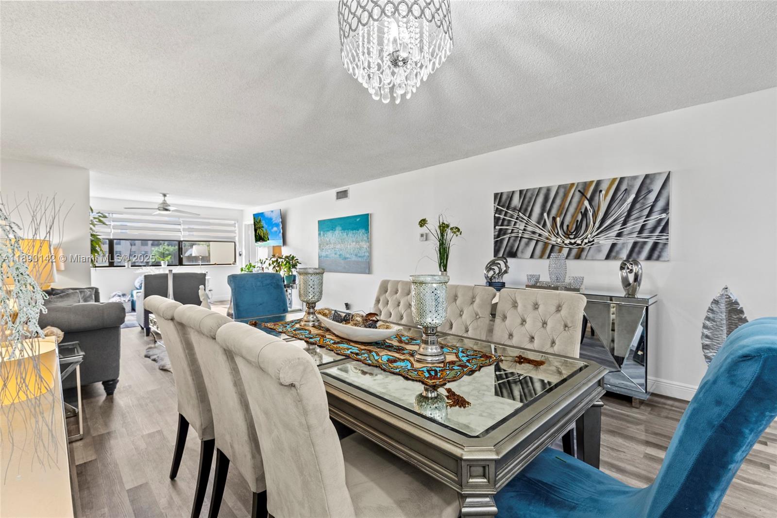 10400 Northwest 30th Court, Unit 202 Sunrise, FL 33322 - Photo 13 of 42 a living room with furniture and a chandelier