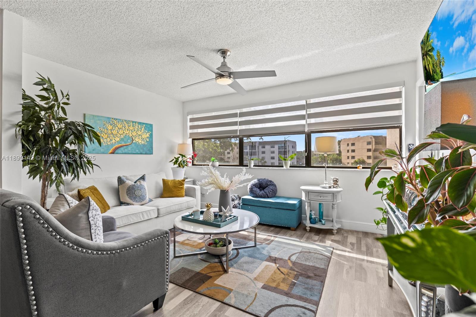 10400 Northwest 30th Court, Unit 202 Sunrise, FL 33322 - Photo 18 of 42 a living room with patio furniture and a potted plant