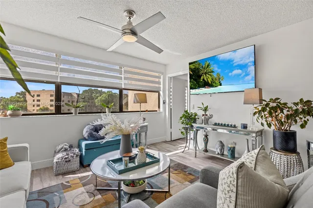 a living room with furniture and a potted plant