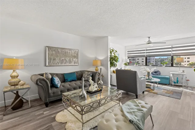 a living room with furniture a rug and a large window