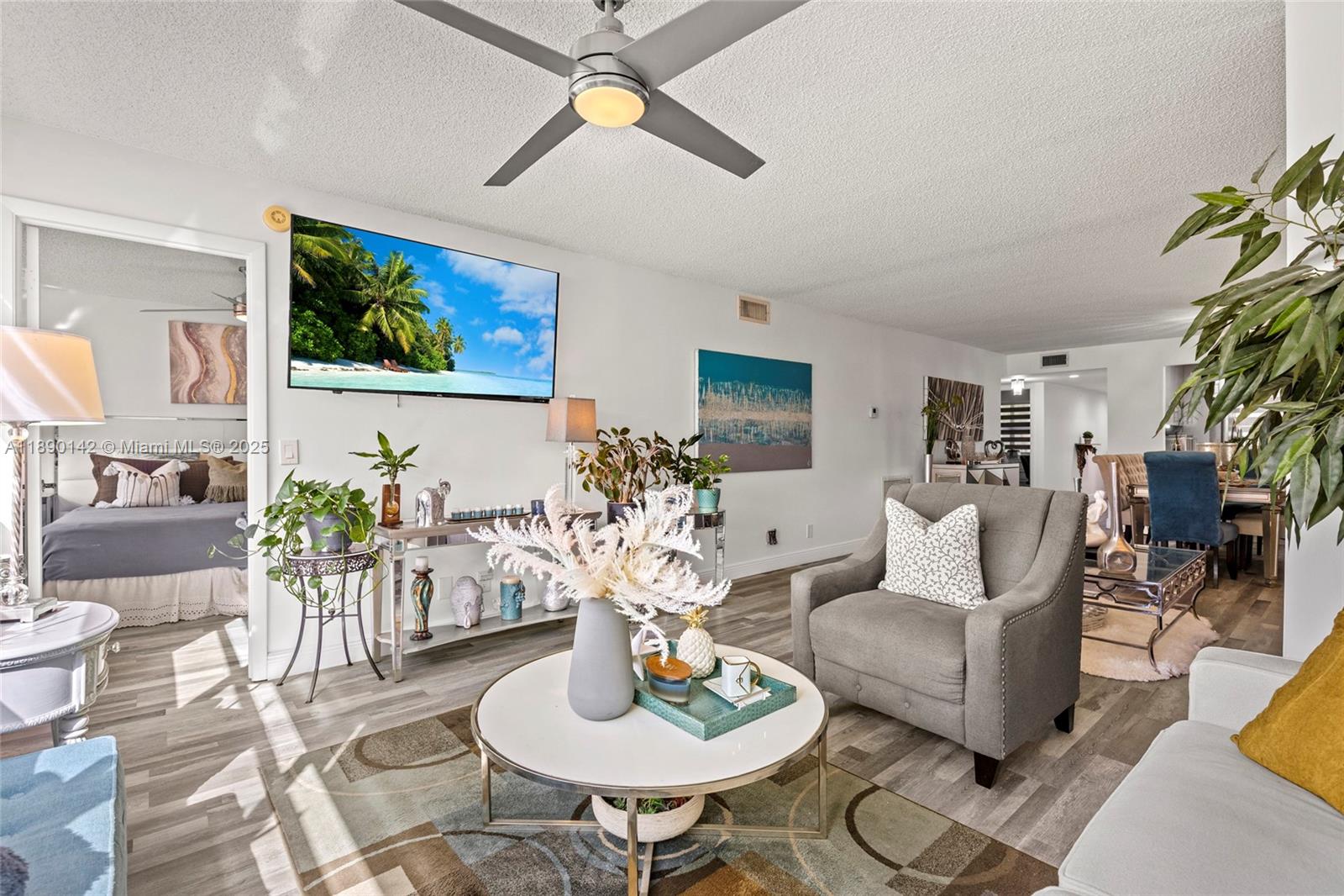 10400 Northwest 30th Court, Unit 202 Sunrise, FL 33322 - Photo 21 of 42 a living room with furniture potted plant and a ceiling fan