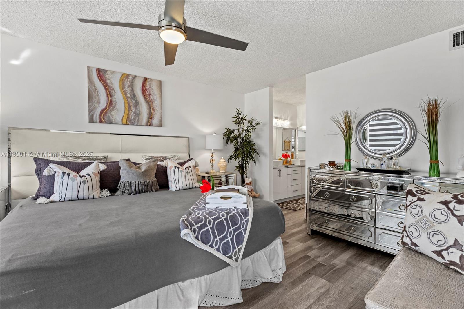 10400 Northwest 30th Court, Unit 202 Sunrise, FL 33322 - Photo 22 of 42 a bedroom with furniture and a chandelier