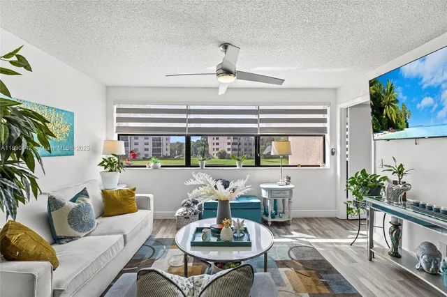 a living room with furniture and a potted plant