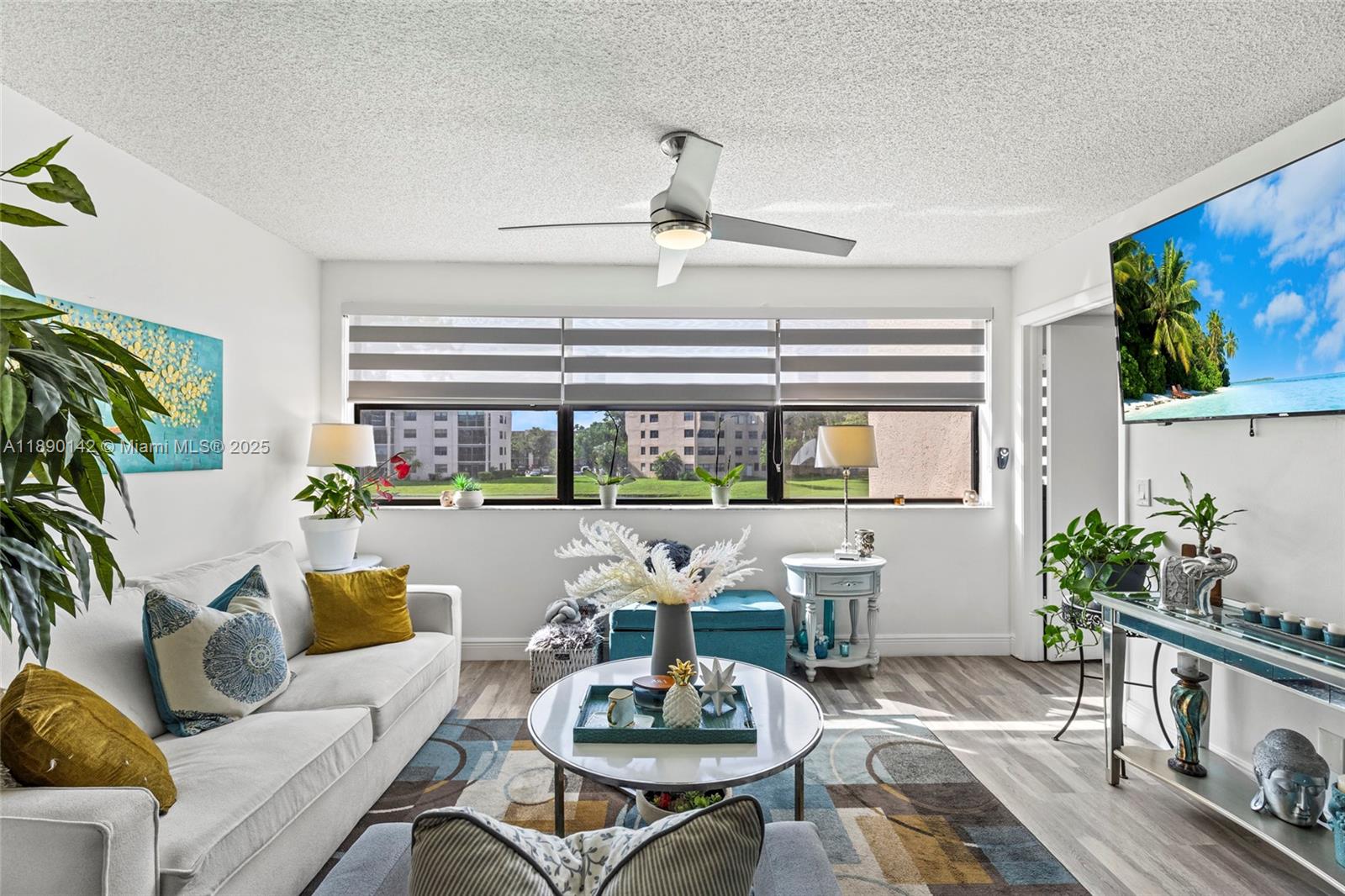 10400 Northwest 30th Court, Unit 202 Sunrise, FL 33322 - Photo 23 of 42 a living room with furniture and a potted plant