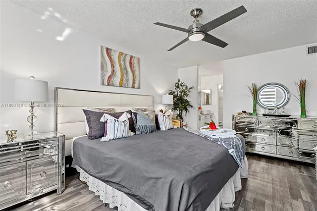 a bedroom with a bed and ceiling fan