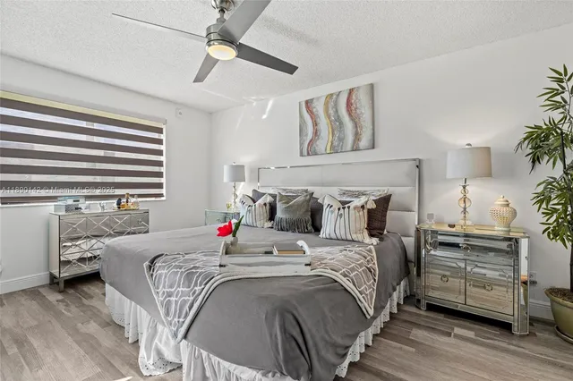 a bedroom with bed and a chandelier