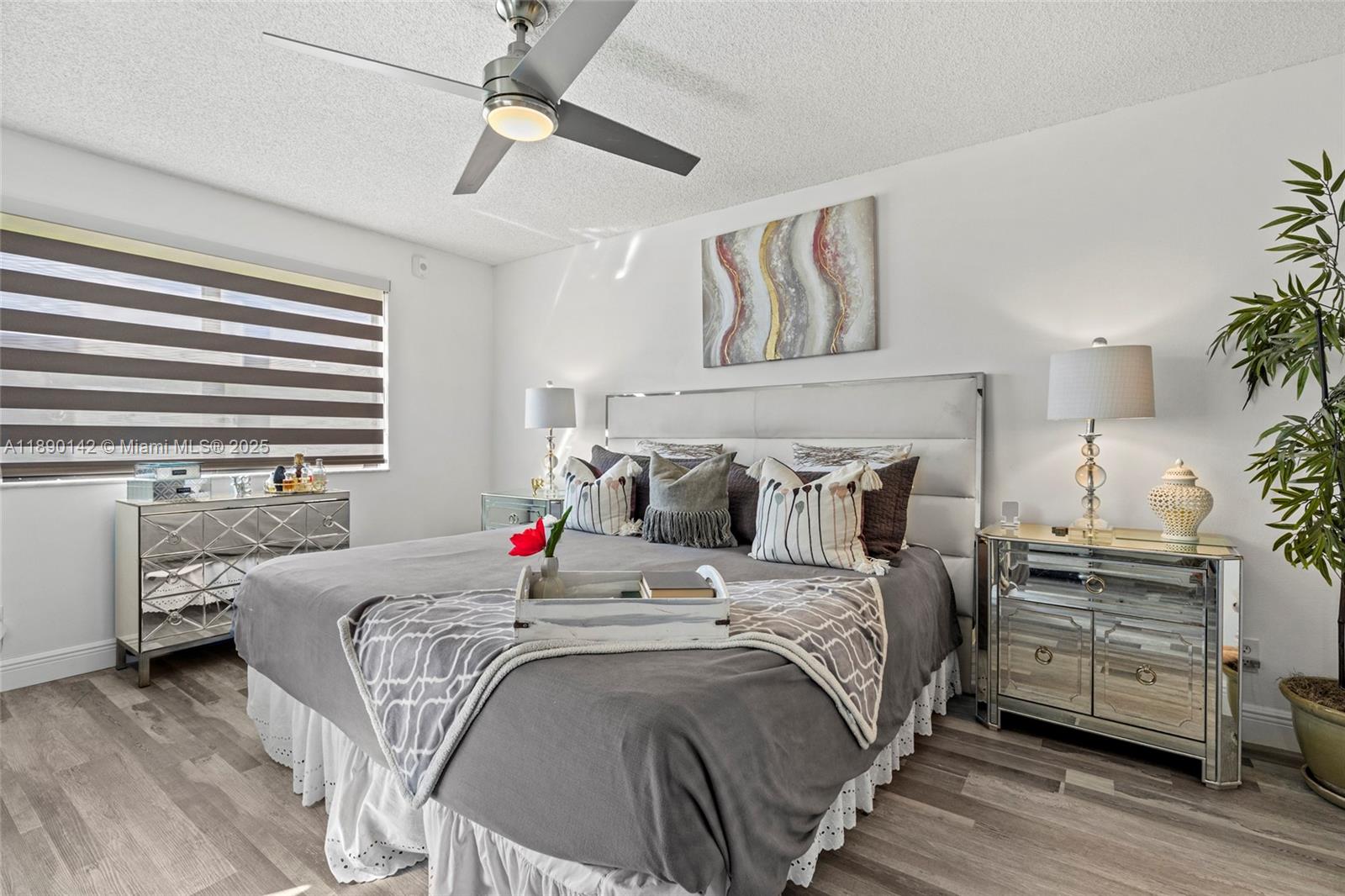 10400 Northwest 30th Court, Unit 202 Sunrise, FL 33322 - Photo 25 of 42 a bedroom with bed and a chandelier