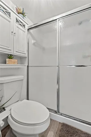 a bathroom with a shower and a toilet