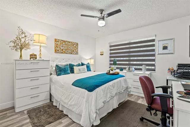 a bedroom with a bed chair and a window