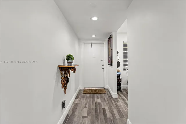 a view of hallway with wooden floor