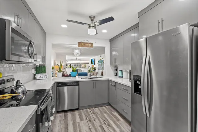 a kitchen with stainless steel appliances a refrigerator sink and cabinets