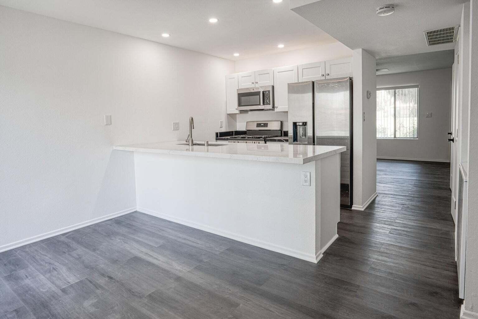 a kitchen with stainless steel appliances granite countertop a sink and cabinets