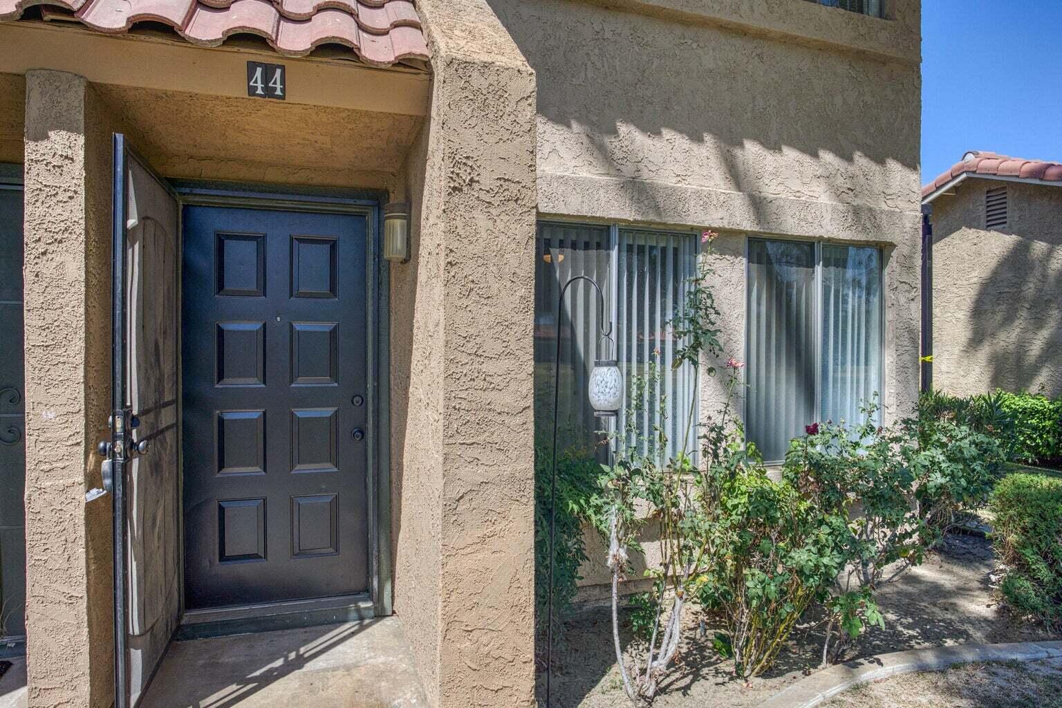 82567 Ave 48, Unit 44 Indio, CA 92201 - Photo 13 of 19 a front view of a house with a glass door