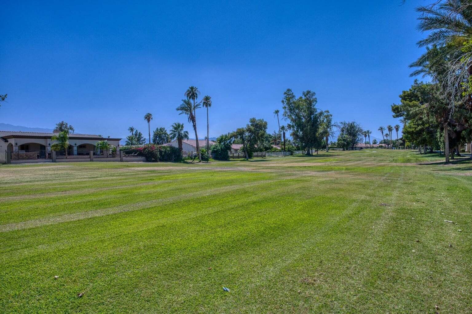 82567 Ave 48, Unit 44 Indio, CA 92201 - Photo 16 of 19 a view of a golf course with a big yard