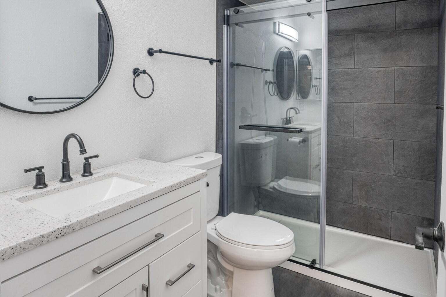 82567 Ave 48, Unit 44 Indio, CA 92201 - Photo 10 of 19 a bathroom with a granite countertop sink a toilet and shower
