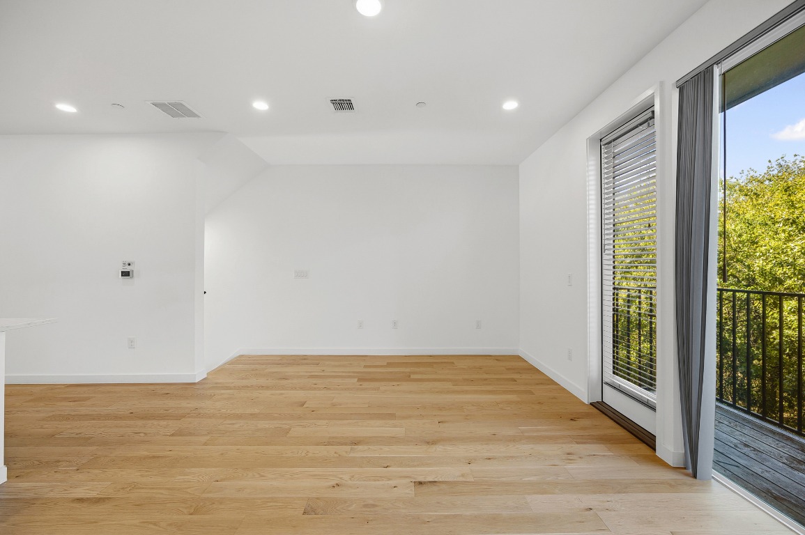 6020 Springdale Road, Unit 12 Austin, TX 78723 - Photo 13 of 28 a view of an empty room with wooden floor and a window