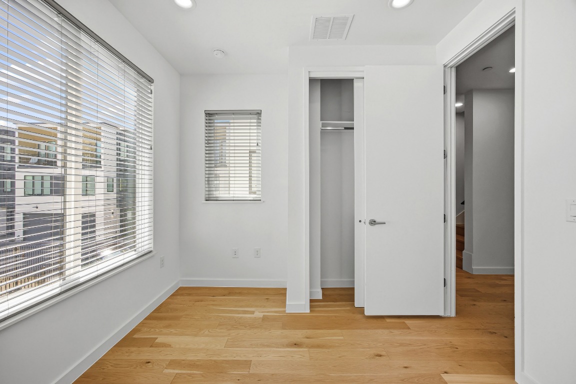 6020 Springdale Road, Unit 12 Austin, TX 78723 - Photo 14 of 28 a view of an empty room with wooden floor and a window