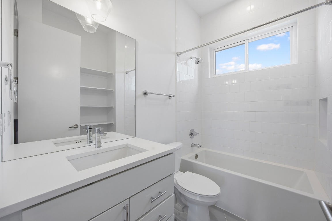 6020 Springdale Road, Unit 12 Austin, TX 78723 - Photo 15 of 28 a bathroom with a sink a toilet and shower