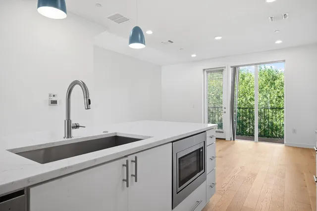 a kitchen with a sink and large window