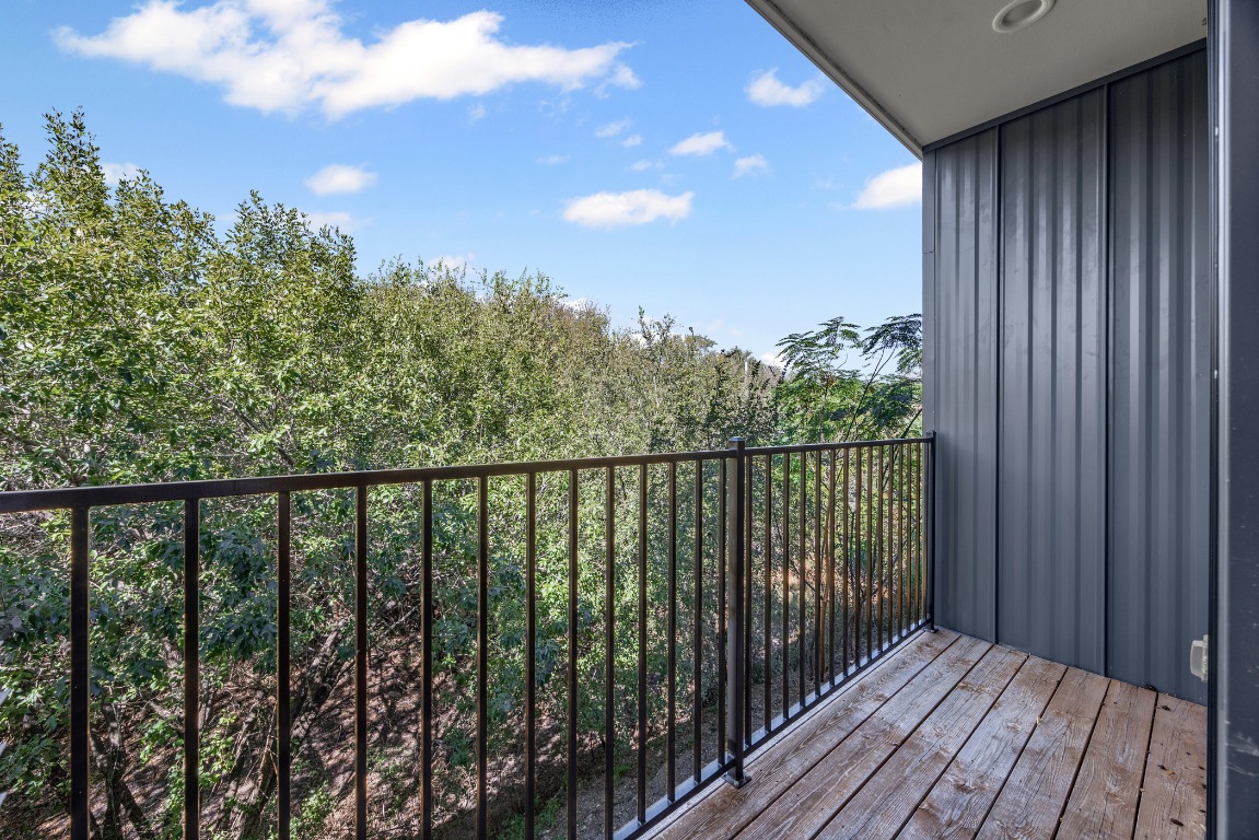 6020 Springdale Road, Unit 12 Austin, TX 78723 - Photo 21 of 28 a balcony with wooden floor and fence