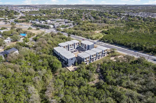 an aerial view of a house with a yard
