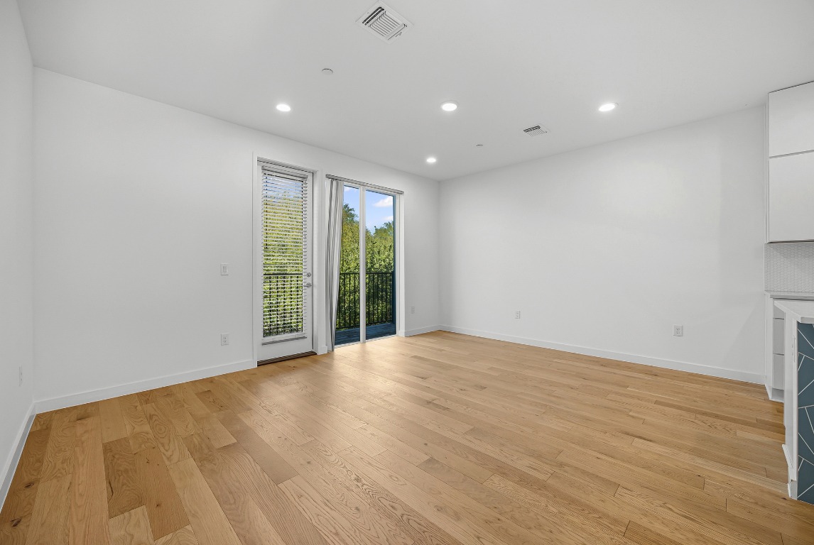 6020 Springdale Road, Unit 12 Austin, TX 78723 - Photo 6 of 28 a view of an empty room with wooden floor and a window