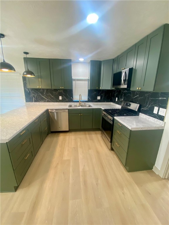 a large kitchen with a sink a counter top space appliances and cabinets