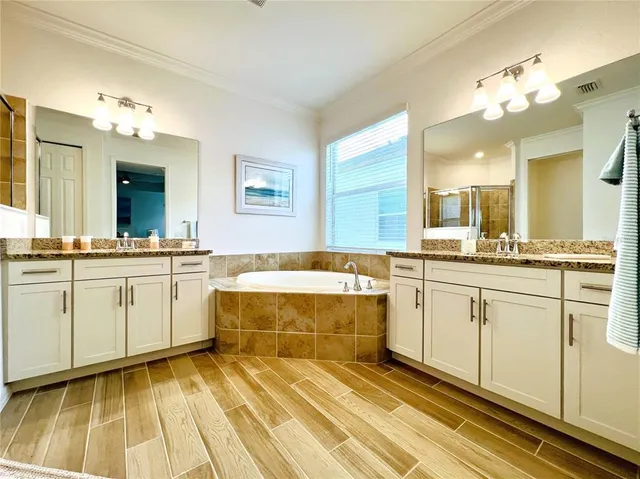 a spacious bathroom with a sink mirror and bathtub