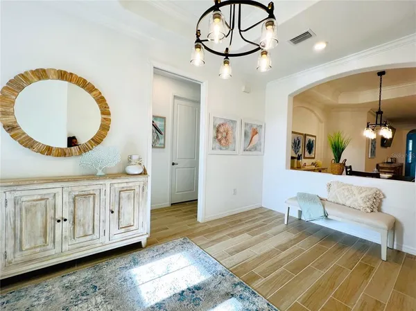 a view of a livingroom with furniture wooden floor and chandelier