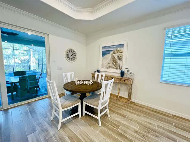 a view of a room with furniture and wooden floor