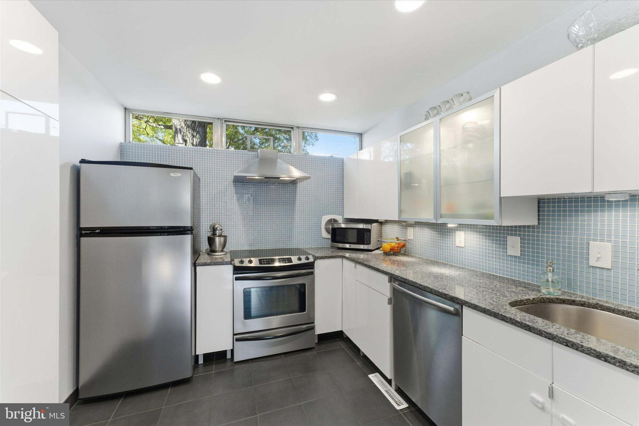 1378 4th Street Southwest Washington, DC 20024 - Photo 11 of 74 a kitchen with stainless steel appliances granite countertop a refrigerator a sink and a stove