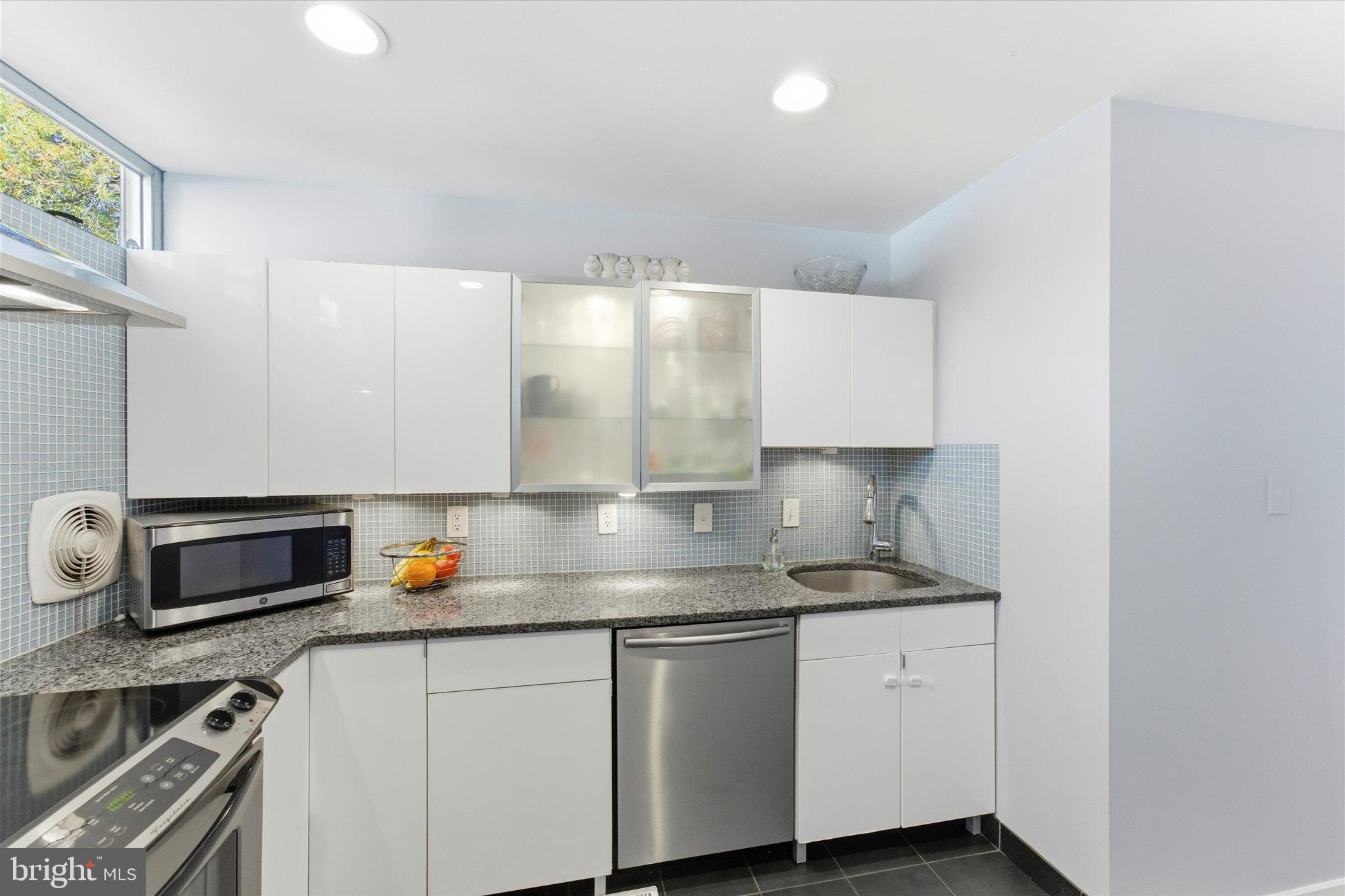 1378 4th Street Southwest Washington, DC 20024 - Photo 14 of 74 a kitchen with stainless steel appliances granite countertop a sink stove and cabinets