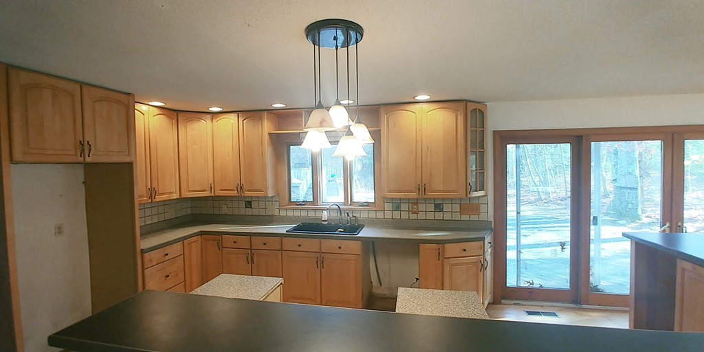 487 Chapin Road Hampden, MA 01036 - Photo 4 of 14 a kitchen with stainless steel appliances granite countertop a sink a stove and a refrigerator