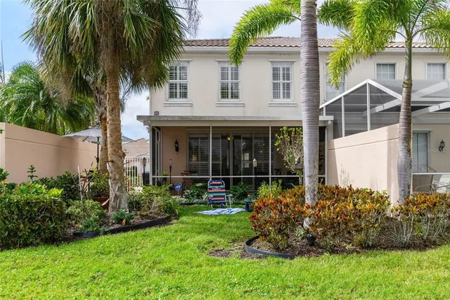a view of house with a yard and potted plants