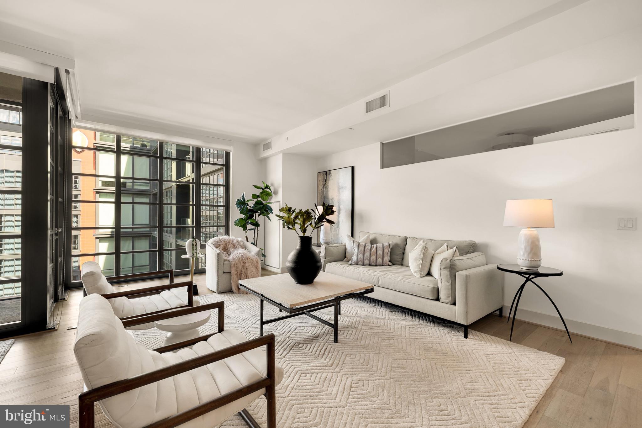 45 Sutton Square Southwest, Unit 906 Washington, DC 20024 - Photo 21 of 50 a living room with furniture and a lamp