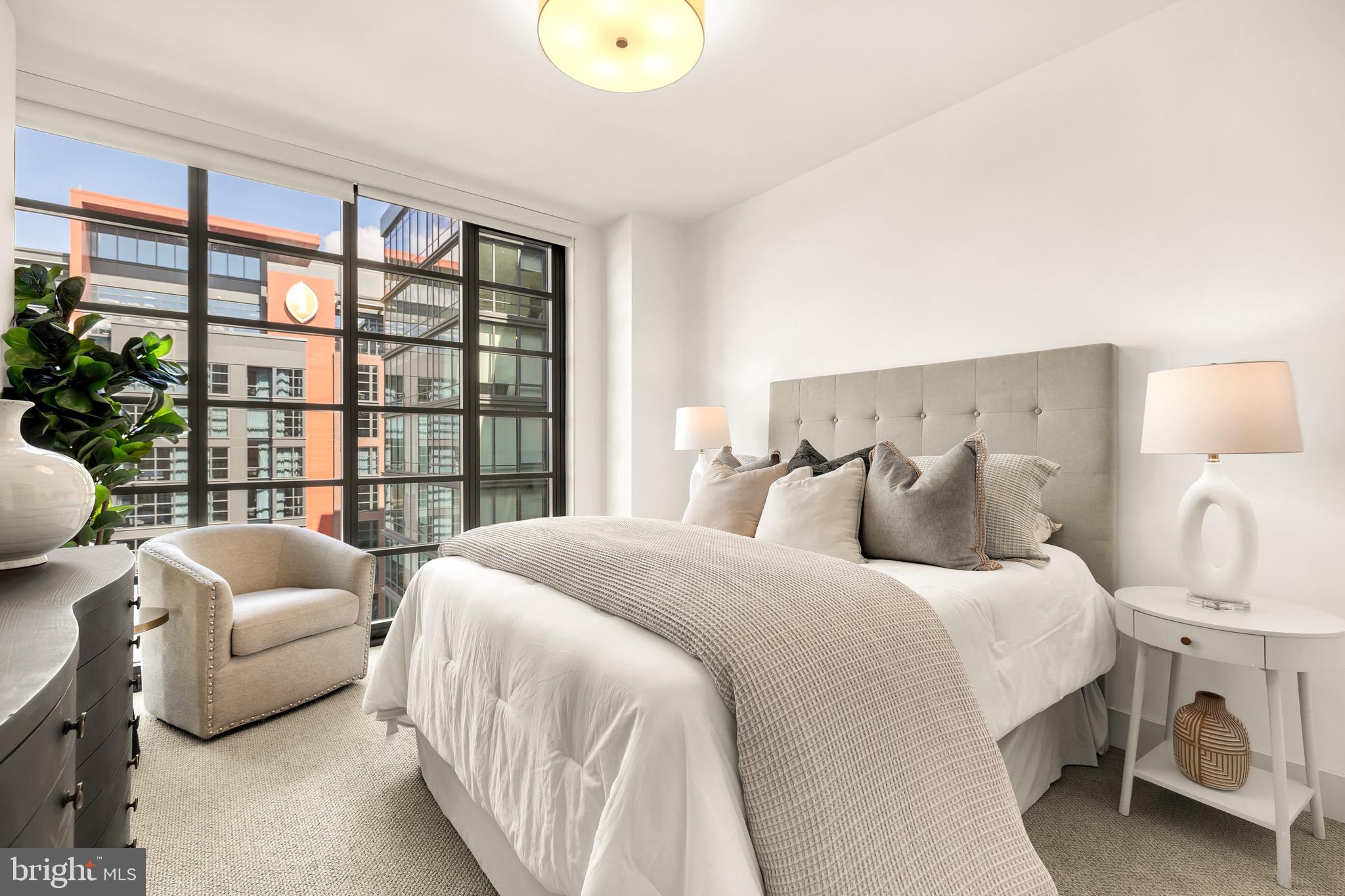 45 Sutton Square Southwest, Unit 906 Washington, DC 20024 - Photo 24 of 50 a bedroom with bed and a large window