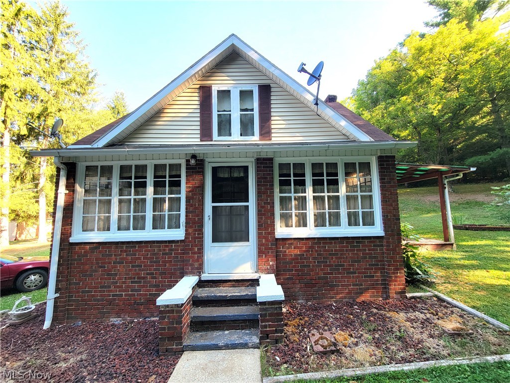 50658 Marietta Road Cumberland, OH 43732 - Photo 1 of 14 Bungalow-style house with a front lawn