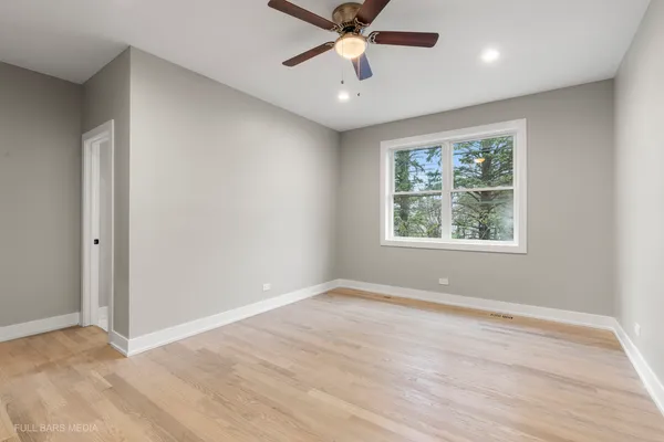 a kitchen with stainless steel appliances a refrigerator a stove a sink and white cabinets