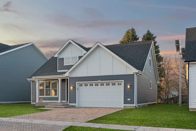 a view of a house with a yard and garage