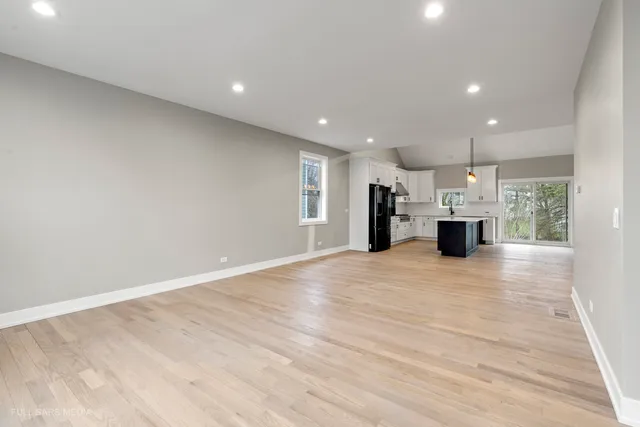 a view of kitchen with refrigerator and window