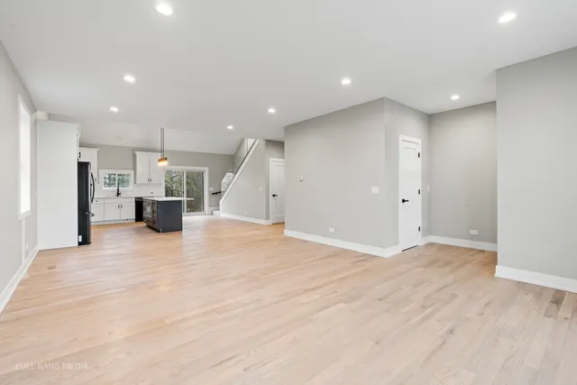 a view of a big room with a refrigerator and a window