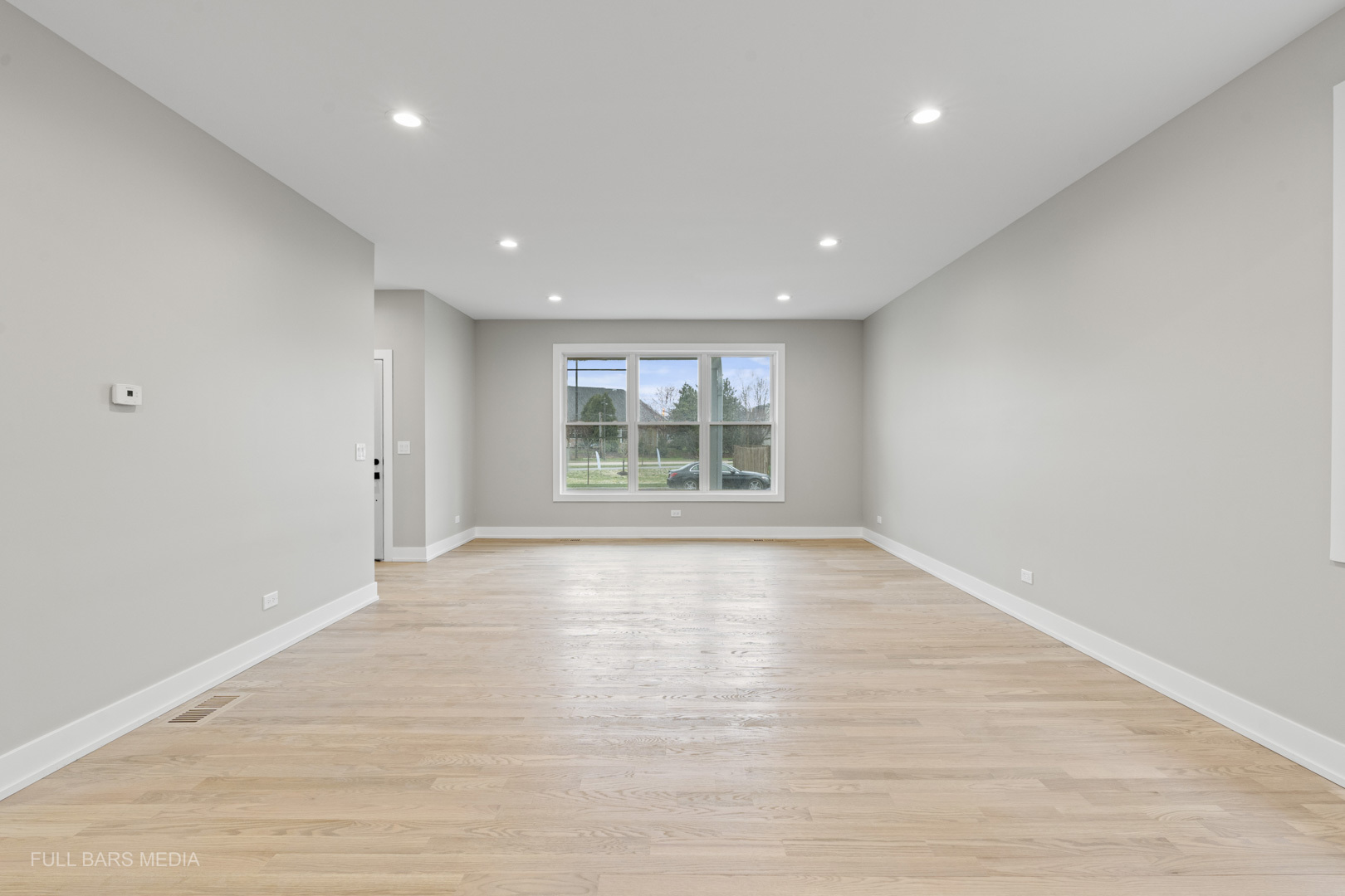 4032 Faith Lane St. Charles, IL 60174 - Photo 6 of 38 a view of an empty room with wooden floor and a window