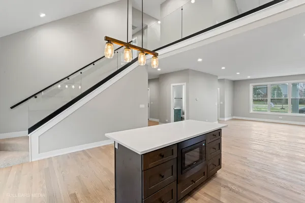 a kitchen with granite countertop a sink stove and cabinets