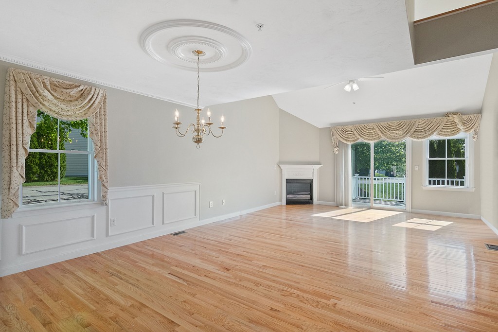 3 Strawberry Lane, Unit A Hudson, MA 01749 - Photo 11 of 29 a view of an empty room with a window and wooden floor