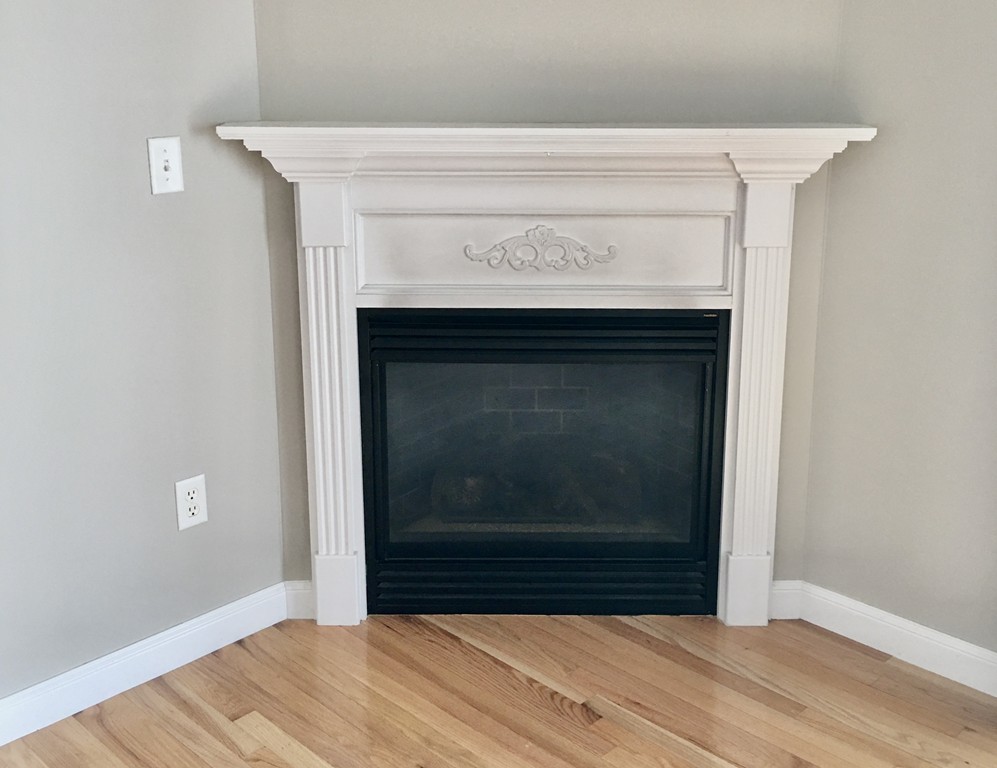 3 Strawberry Lane, Unit A Hudson, MA 01749 - Photo 12 of 29 a view of empty room with wooden floor and fireplace