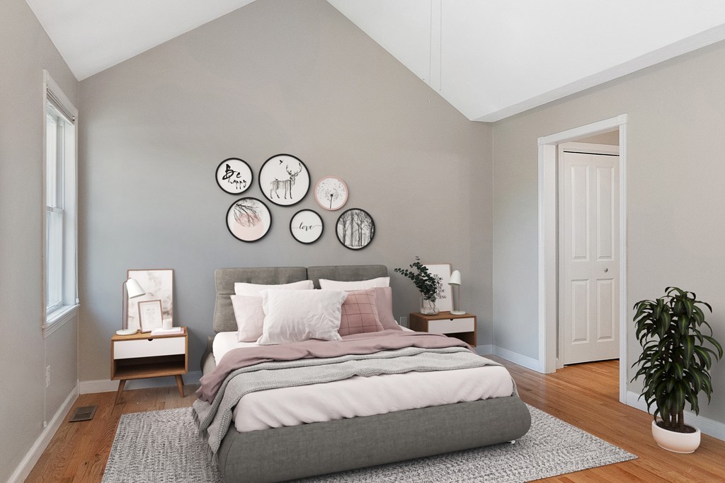 3 Strawberry Lane, Unit A Hudson, MA 01749 - Photo 15 of 29 a bedroom with a bed and a potted plant