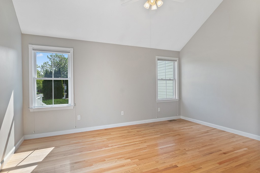 3 Strawberry Lane, Unit A Hudson, MA 01749 - Photo 16 of 29 a view of an empty room with wooden floor and a window