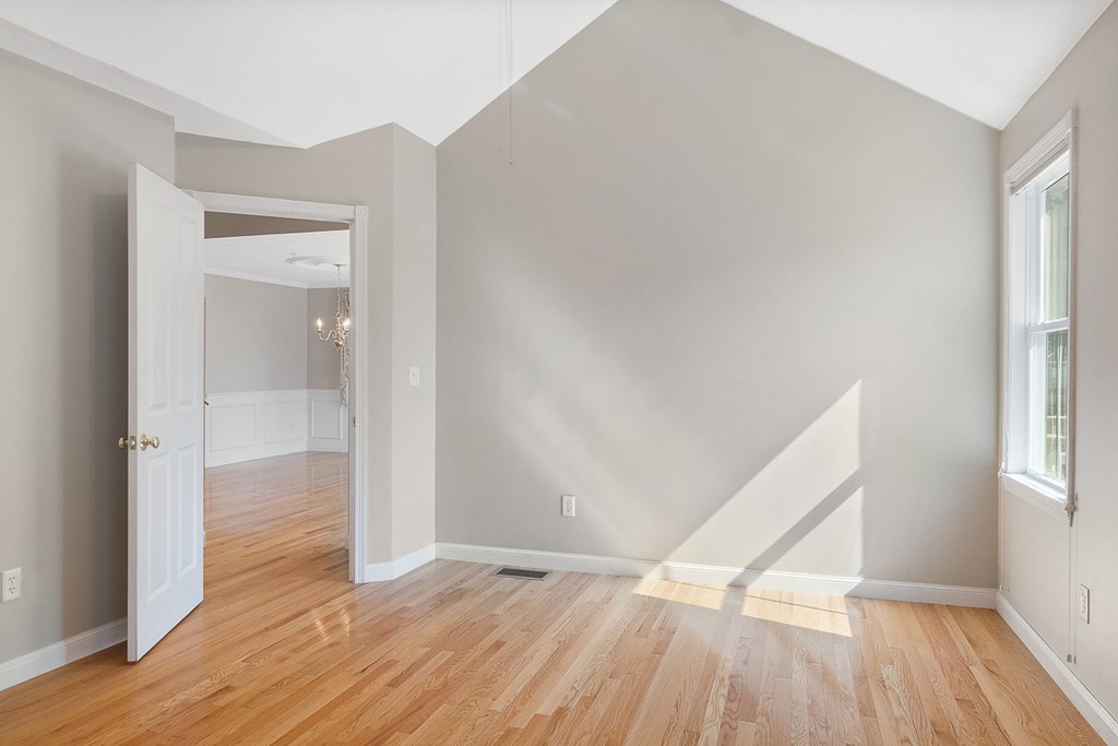 3 Strawberry Lane, Unit A Hudson, MA 01749 - Photo 17 of 29 an empty room with wooden floor and windows