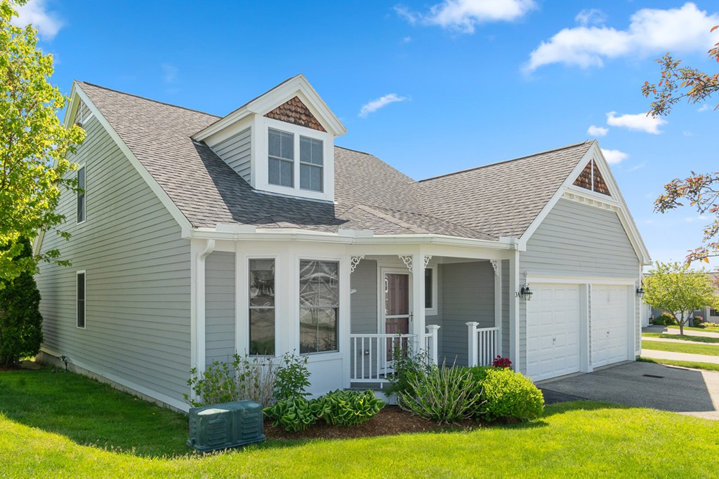 3 Strawberry Lane, Unit A Hudson, MA 01749 - Photo 2 of 29 a front view of a house with a yard and porch